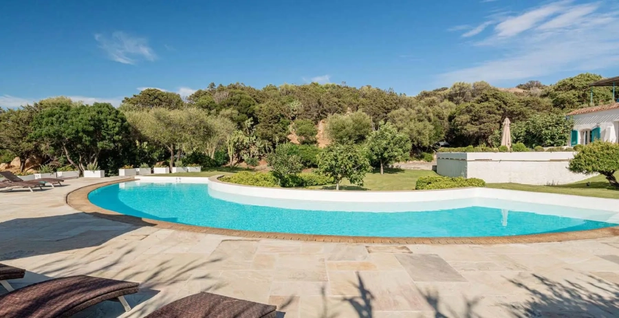 Private sandy beach steps from the villa lawn in Liscia di Vacca